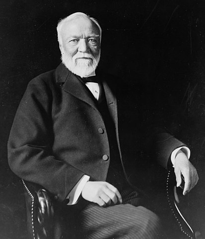 Portrait of Andrew Carnegie with white beard, sitting in a chair
